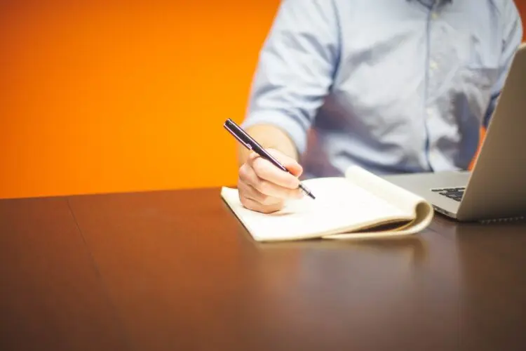 person writing the notes