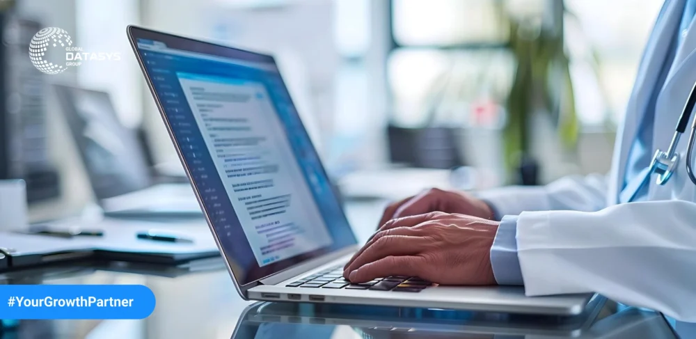 Healthcare professional typing on a laptop in an office setting, symbolizing strategies for enhancing B2B healthcare email marketing.