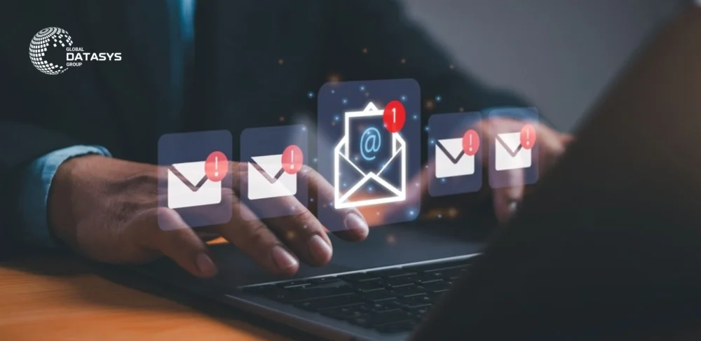 Professional using email marketing software with email icons and notification alerts, representing automated B2B campaigns by Global Datasys Group.
