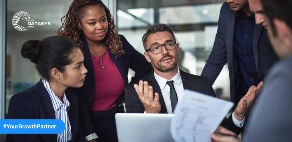 Business professionals discussing strategy at Global Datasys Group – Your Growth Partner in data-driven solutions.